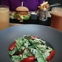 A smoothie, fresh juice, Caesar salad with vbacon and a cheezeburger at Green Pumpkin in Riga