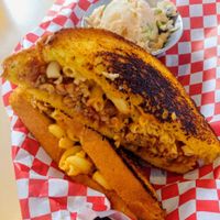 Hawaiian bread filled with smoked tempeh, vegan mac n' cheese and MFT chocolate rasberry bbq sauce and a side of vegan potato salad at BBQ4Life in Boise
