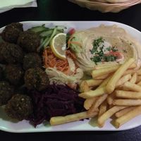 ‘Premium plate - vegetarian’ = falafel, houmous, salads, fries served with pitta  at Olive Tree Hummus Original in Budapest