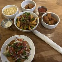 Clockwise from top left: Mac and cheese, chicken nuggets, fried cheese bites, fish taco, loaded fries (centre)   at Veggie Grill by Next Level in Pasadena