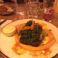 Flavorful seitan steak lined with sweet potato mash, vegan mayo on the side at ONDA in Helsinki