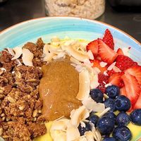 Mango 🥭 Bowl with strawberries 🍓 blueberries 🫐 peanut 🥜 butter 🧈 coconut 🥥 shaving’s 🍌 banana & granola  at Lotta Love in Malmo