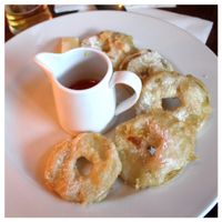 battered, deep fried Brambly apple rings, dusted with sugar, with golden syrup - Vegan. at The Red Lion Pub in East London