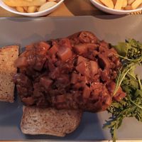 Vegan seitan goulash with tomato sauce, potatoes and mushrooms at Il Vegano Bistrot in Florence