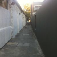 Walk down long narrow alley-way, at sign, to get to cafe at Blue Gate Cafe  in Chiang Mai