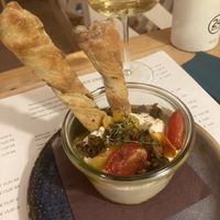 Alone ricotta with tomato confit and fried capers and homemade olive bread twists   at Romeow Cat Bistrot in Rome