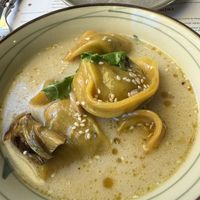 Cappellotti ripieni di anacardi sfumati al prosecco , cipollotti , funghi . Infuso di cocco , curry e lemongrass  at Romeow Cat Bistrot in Rome