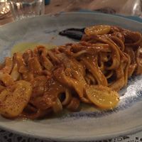 Homemade mixed grains fettuccine with four cherries tomato sauce and black garlic cream at Romeow Cat Bistrot in Rome