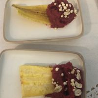 Complementary welcome appetizer. I believe it was a plantain(?) chip with beetroot hummus.  at Romeow Cat Bistrot in Rome