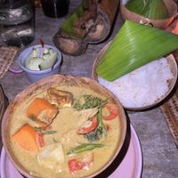 yellow curry with tofu, sweet potato and other vegetables. comes with rice and cucumber salad  at Mezzanine in Tulum
