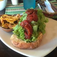 Home baked bread with humus, juicy sun-dried tomatoes and banana chips ?  at Ikaro Cafe in Santa Marta