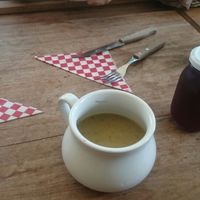 soup and chicha served in cute plates and cup at Centeno Restaurante Vegetariano in Medellin