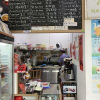 Uncle chef preparing my meal with much love at Nature's Harvest Cafe in Central Singapore