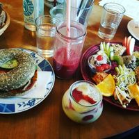 (from left to right) bread that comes with the large breakfast, sweet potato bagel, red berry smoothie, chia pudding, large breakfast at Geh Veg in Berlin