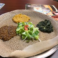 #19, yellow lentil, and kale potato - comes with the salad and the bread which you eat the sides with  at Kibrom's in Boise