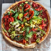 Vegan pizza with label and a ton of veggies at Blaze Pizza in Gainesville