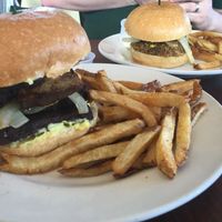 The Crazy Jamaican Burger: Jamaican spiced tofu, caramelized sweet plantain, grilled sweet onions, tomatoes, potato salad(vegan), topped with vegan mayo. at Quickie Too in Tacoma