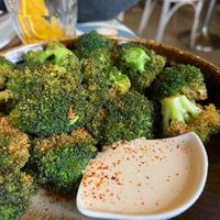 Crispy broccoli with citrus tahini sauce (12€) — very tasty! at VEGA - Luna in Madrid