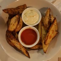 Potatoe wedges with aioli and spicy sauce at VEGA - Luna in Madrid