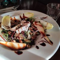 Delicious salad (main dish) with pears, vegan cheese, caramelised walnuts,... at Hagedis in The Hague