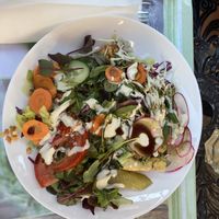 Some layered baked dish, covered with veggies  at Edeni Vegan in Budapest