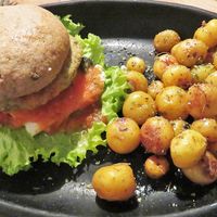 The potatoes were yummy, but the burger was a bit dry and didn't have a lot of flavor. at Nativa in Bogota