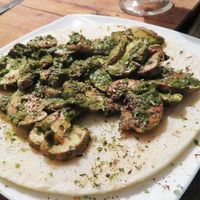 The mushrooms with pesto sauce were nice, but the arepa had no flavor at all. I know basic arepas without filling taste like this, but they could have compensated a bit more with the topping. at Nativa in Bogota