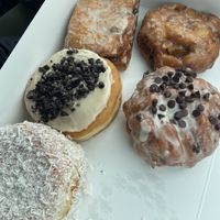 Coconut cream, dutchie, apple fritter, banana chocolate fritter & cookies ‘nd cream   at Beechwood Doughnuts in St Catharines