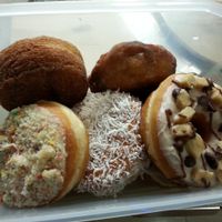 Bring your own Tupperware and get 10% off! From top left...cronut, apple fritter, cookie dough, coconut cream, birthday cake, and chunky monkey (hidden underneath). at Beechwood Doughnuts in St Catharines
