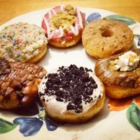 In clockwise order from the top: raspberry white chocolate cheesecake, French toast, salted caramel mocha, cookies and cream (my personal favorite!), cherry chocolate fritter, and birthday cake. Photo taken February 2018. at Beechwood Doughnuts in St Catharines