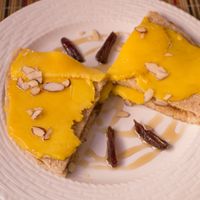 Breakfast item: oat pancakes layered with fresh mango, with dates and slivered almonds. at Kalenda in Santo Domingo