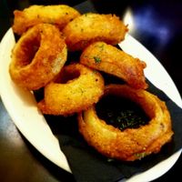 Vegan beer battered onion rings (special order). Their onion rings are not normally vegan.   at The Elusive Cow in Bellevue