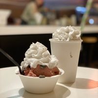 2 scoops Strawberry ice cream 🍓 with whipped cream and chocolate chips paired with a cookies n’ cream shake at Cashew Cow in Tucson