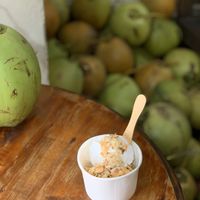 Two scoops of coconut ice cream with shaved coconut and coconut brittle at Tukies Coconut Shop  in Ubud
