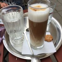 oat latte served in glass at Cukrárna in Brno