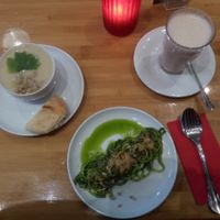 Zucchini pasta with spinach-cashew sauce and pearl barley soup with oat-chai-latte. at Sol in Konstanz