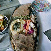 Plate of the day Veggie pie, fava hummus, falafel balls with tahini sauce and fermented veggies at Andriakon in Andros