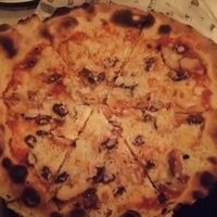 Pizza with olives and bakes potato at Ziona in Ness Ziona