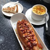 The Bourbon hot dog, side of Mac and Cheese, Biscoff Cheesecake at Vegan Antics in Gravesend
