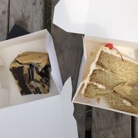 Cookies&Cream cookie pie (£8😵‍💫) and a (very sad and broken) slice of pina colada cake which didn’t have enough buttercream nor pineapple pieces.  at Vegan Antics in Gravesend