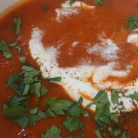 Polish tomato soup with Polish gnocchi-'kluseczki' and sour cream on top. Delicious. at Lokal Vegan Bistro in Warsaw