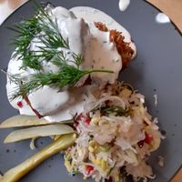Potato pie, creamy dill sauce, gherkin, sauerkraut with pomegranate seeds at Lokal Vegan Bistro in Warsaw