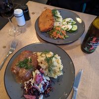 Sausage like thing with pickles inside and schnitzel at Lokal Vegan Bistro in Warsaw