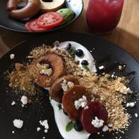 Avocado bagel plate (top) and stone fruits dish (bottom. With blurry mint juice.  at Scarecrow in Auckland