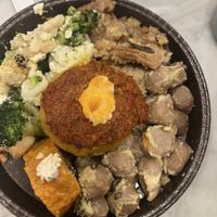 Plate with polenta, gnocchi, pumpkin roll, soy pieces with white wine sauce, vegetables with a cheese substitute (like ricotta)  at Giumella in Florence