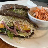 Raw sandwich with onion bread and coleslaw  at Eternal Abundance in Vancouver