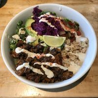 Burrito Bowl on Special, black beans, brown rice, greens, avocado, salsa & topped with Sunflower Sour cream And a lime wedge.  at Eternal Abundance in Vancouver