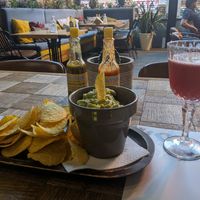 A big serve of yummy guacamole with corn chips and proper hot sauce! at Amigos in Skopje