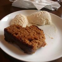 Warm ginger and apple cake with vanilla ice cream (vegan) at The HiVe Cafe. at The HiVe Cafe in Weymouth