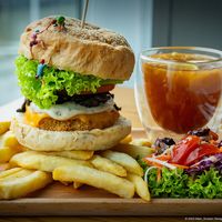 Lion’s Mane Extreme Burger with salad & fries and comes with a Lemon Passion Fruit Tea  at nomVnom Bistro - Clarke Quay in Central Singapore